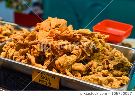 Fried chicken skin in the street food Jalan Alor in Kuala Lumpur 106730097