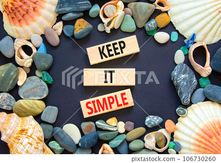 Keep it simple symbol. Concept word Keep it simple on beautiful wooden block. Sea shell stone. Beautiful black table black background. Business motivational keep it simple concept. Copy space. Keep it simple symbol. Concept word Keep it simple on beautiful wooden block. Sea shell stone. Beautiful black table black background. Business motivational keep it simple concept. Copy space. 106730260
