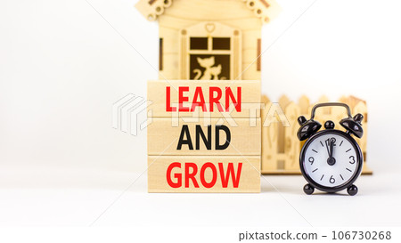 Learn and grow symbol. Concept word Learn And Grow on beautiful wooden block. Black alarm clock. Beautiful white table white background. Business, education learn and grow concept. Copy space. Learn and grow symbol. Concept word Learn And Grow on beautiful wooden block. Black alarm clock. Beautiful white table white background. Business, education learn and grow concept. Copy space. 106730268