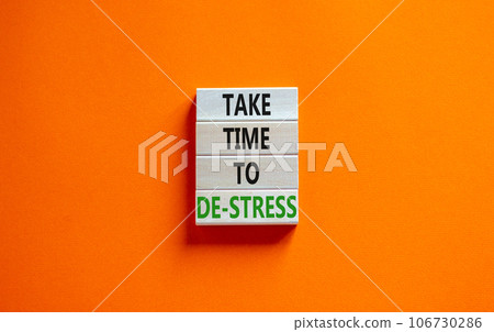 Take time to de-stress symbol. Concept words Take time to de-stress on wooden blocks. Beautiful orange table orange background. Psychological business and take time to de-stress concept. Copy space. 106730286
