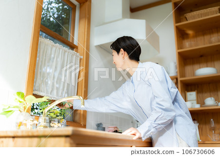 woman opening kitchen window 106730606