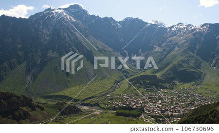 Amazing landscape view of Stepantsminda town in Georgia surrounded by Mountains Amazing landscape view of Stepantsminda town in Georgia surrounded by Mountains 106730696