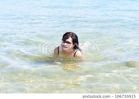 Happy 45 years old Russian woman swimming Japanese sea Happy 45 years old Russian woman swimming Japanese sea 106730915