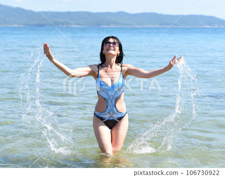 Happy 45 years old Russian woman swimming Japanese sea Happy 45 years old Russian woman swimming Japanese sea 106730922