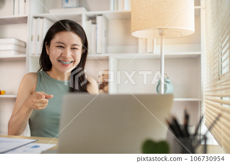 Young woman Working from Home, Video Call with Customer in Office, Remote Business Communication, Telecommuting Professional, Virtual Video Call with Office Customer, Work from Home Concept. 106730954