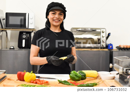Mexican woman laughing during cooking tacos in the kitchen Mexican woman laughing during cooking tacos in the kitchen 106731032