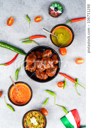 Polanco chicken with mexican secret sauce on black plate with decorations 106731298