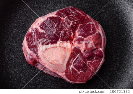 Fresh beef ossobuco steak with salt, spices and herbs Fresh beef ossobuco steak with salt, spices and herbs 106731583