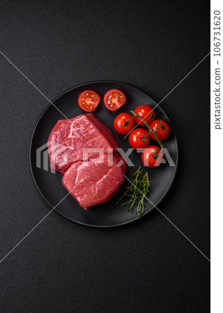 Raw fillet steak mignon beef with salt, spices and herbs 106731620