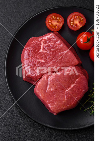 Raw fillet steak mignon beef with salt, spices and herbs 106731623