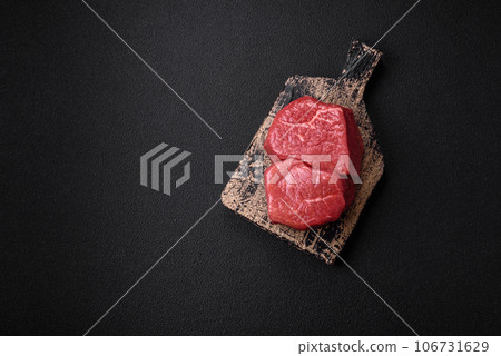 Raw fillet steak mignon beef with salt, spices and herbs 106731629
