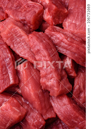 Raw organic meat beef or lamb cut into slices with salt, spices and herbs 106731669