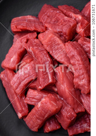 Raw organic meat beef or lamb cut into slices with salt, spices and herbs 106731671