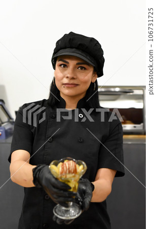Mexican woman serving santa fe (caramelized banana with whisky) in mexican cafe Mexican woman serving santa fe (caramelized banana with whisky) in mexican cafe 106731725