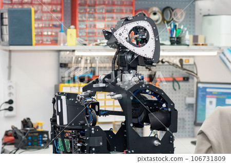 humanoid robot in the process of assembly and adjustment in the workshop 106731809