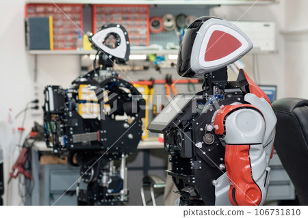 humanoid robots in the process of assembly and adjustment in the workshop 106731810