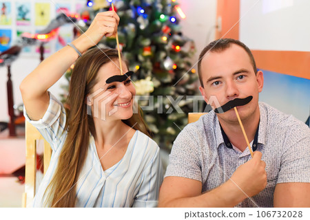 Two friends Russian and Slovak having fun in against chistamas tree at home Two friends Russian and Slovak having fun in against chistamas tree at home 106732028