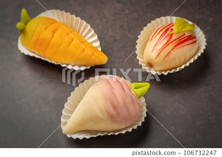 Portuguese marzipan delicacy in the shape of fruit apple, carrot, beet. Gourmet sweets from the Algarve Portugal on a marble background close-up. Portuguese marzipan delicacy in the shape of fruit apple, carrot, beet. Gourmet sweets from the Algarve Portugal on a marble background close-up. 106732247