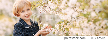 Girl in blooming apple orchard Girl in blooming apple orchard 106732504