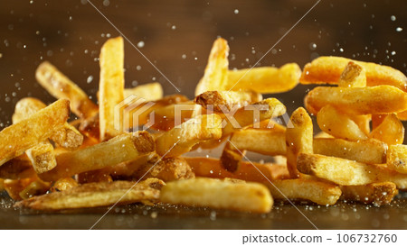 French fries - fried potatoes hitting the table. French fries - fried potatoes hitting the table. 106732760
