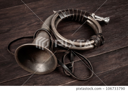 Hunting horn on rustic wood plank. Hunting horn on rustic wood plank. 106733790