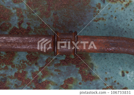 Rusty plumb tube on rusty metal wall Rusty plumb tube on rusty metal wall 106733831