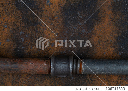 Rusty valve pipes on rusty metal wall Rusty valve pipes on rusty metal wall 106733833