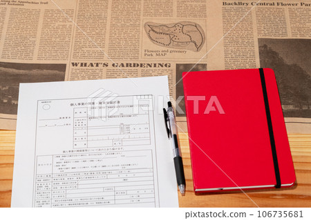 Opening business registration form, pen and red notebook laid out on the desk Opening business registration form, pen and red notebook laid out on the desk 106735681