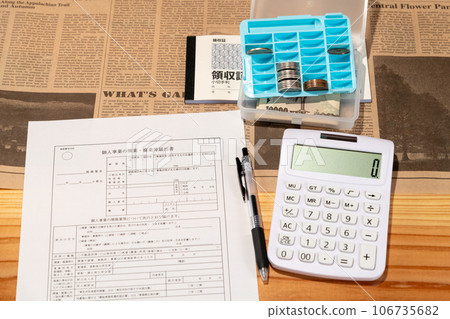 Business opening registration form, calculator, money, and receipts laid out on the desk Business opening registration form, calculator, money, and receipts laid out on the desk 106735682