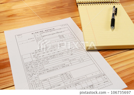 Opening business registration form, pen and memo pad spread out on the desk Opening business registration form, pen and memo pad spread out on the desk 106735697