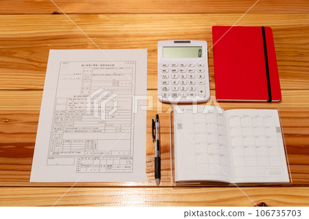 Business opening notification form, pen, schedule book, and stationery laid out on the desk Business opening notification form, pen, schedule book, and stationery laid out on the desk 106735703
