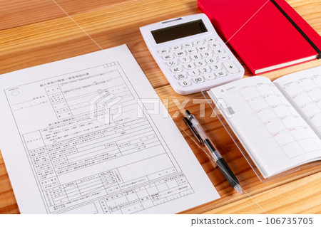 Business opening notification form, pen, schedule book, and stationery laid out on the desk Business opening notification form, pen, schedule book, and stationery laid out on the desk 106735705