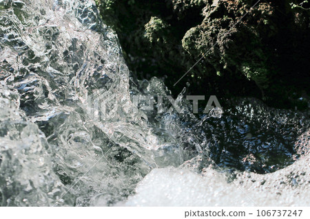 A monochrome illustration-style retouched photo of clear stream water flowing between moss-covered stones and a waterfall basin. 106737247