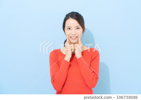 Portrait of a woman in her 20s wearing red clothes Portrait of a woman in her 20s wearing red clothes 106738086