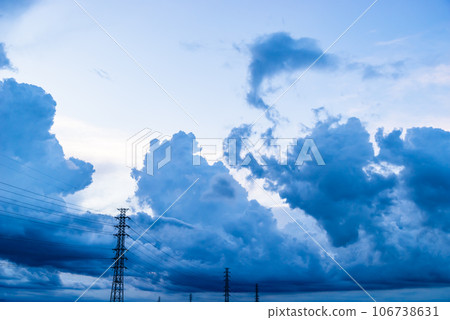 Dark clouds on a summer evening rising in the sky behind the power transmission tower c-2 High chroma contrast 106738631