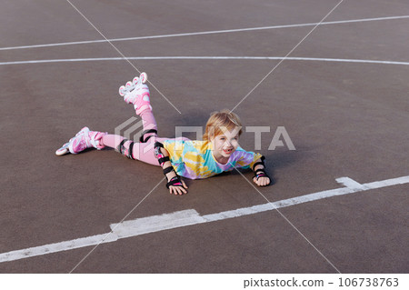 A little girl fell on roller skates. Learns to ride. A little girl fell on roller skates. Learns to ride. 106738763