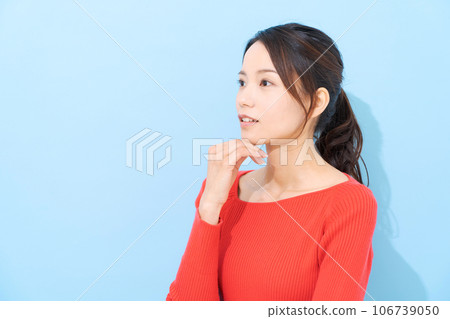 Portrait of a woman in her 20s wearing red clothes Portrait of a woman in her 20s wearing red clothes 106739050
