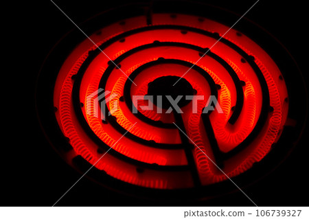 黑色背景上帶有紅色加熱絲（捲繞鎳鉻合金絲）的複古電爐照片 106739327