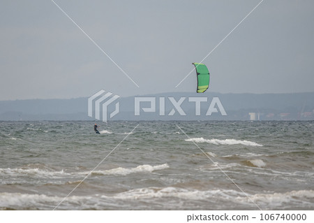 Melbystrand Sweden A kitesurfer practise his surfing skills close to beach with sand dunes 106740000