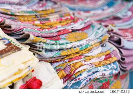 Multi-colored towels on the counter of a trade tent at a fair. Close-up. 106740223