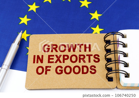 Economy and finance concept. On the flag of the European Union lies a pen and a notepad with the inscription - growth in exports of goods. Economy and finance concept. On the flag of the European Union lies a pen and a notepad with the inscription - growth in exports of goods. 106740250