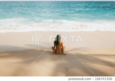 Bikini Beach Girl in Red Swimsuit on Tropical Seashore Under Palm Tree Shade During Sea Vacation 106741500