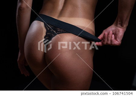 A faceless woman in black panties shows off the result of an instant tan A faceless woman in black panties shows off the result of an instant tan 106741504