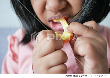 child mouth eating gummy candies closeup 106743435