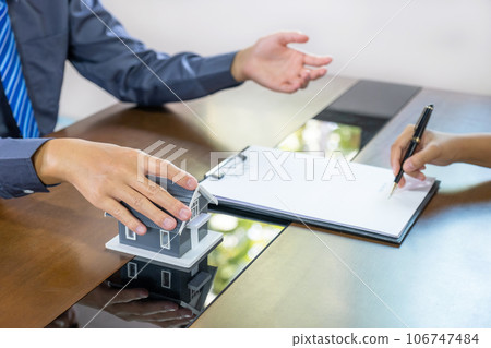 Real estate agents and buyers discuss signing a business contract, renting, buying, mortgage, loan or home insurance Real estate agents and buyers discuss signing a business contract, renting, buying, mortgage, loan or home insurance 106747484