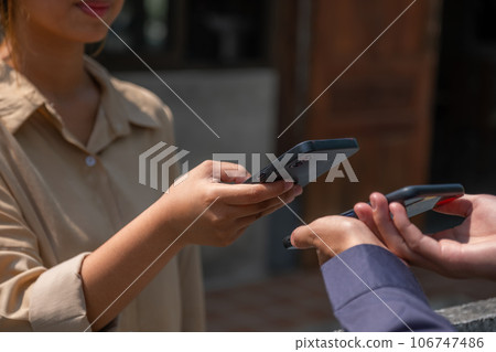 Asia customer woman scan QR code payment and pick up purchase online shopping food, Grocery man delivers service organic vegetable and fruit Asia customer woman scan QR code payment and pick up purchase online shopping food, Grocery man delivers service organic vegetable and fruit 106747486