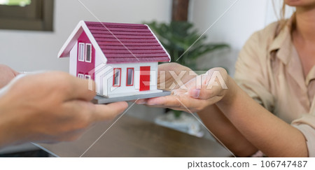 Real estate agents and buyers discuss signing a business contract, renting, buying, mortgage, loan or home insurance Real estate agents and buyers discuss signing a business contract, renting, buying, mortgage, loan or home insurance 106747487