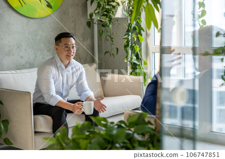 Businessman take break drinking coffee and discussing business strategy in office resting room. 106747851