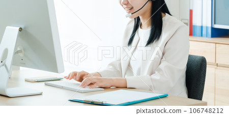 Young woman working in a call center Young woman working in a call center 106748212