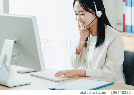 Young woman working in a call center Young woman working in a call center 106748222